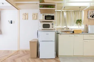 a kitchen with a refrigerator and a microwave at Beige2nd in Tokyo