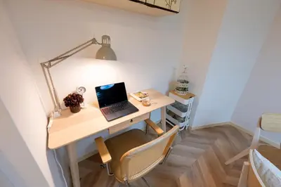 a desk in a room with a laptop on it at Beige2nd in Tokyo