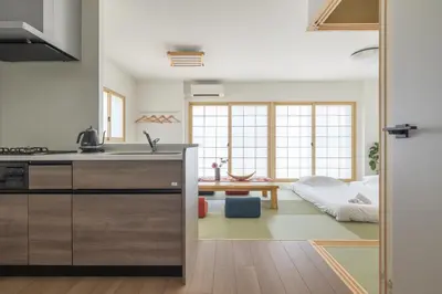 a kitchen with a sink and a living room at Tsubasa Home in Tokyo