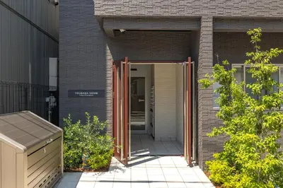 an open door into a brick building at Tsubasa Home in Tokyo