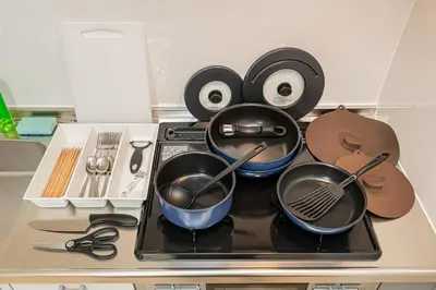 a stove with pots and pans on top of it at KYARA Hotel\u30df\u30b9\u30df302 in Tokyo