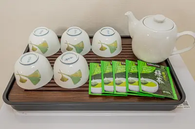 a tray with a group of teapots and tea packets at KYARA Hotel\u30df\u30b9\u30df302 in Tokyo