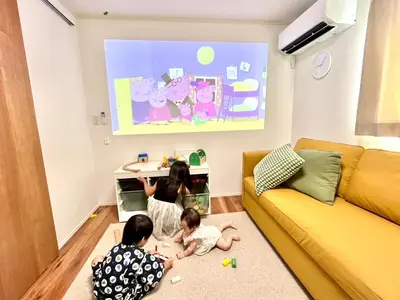 two children are playing in a living room at HOTEL Grand Star Tokyo in Tokyo