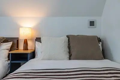 a bedroom with a bed with a lamp on a table at Modern Japan \u6771\u4eac\u6d45\u8349 east in Tokyo