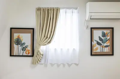 a window with white curtains and two pictures at Modern Japan \u6771\u4eac\u6d45\u8349 east in Tokyo