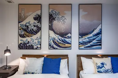 a room with three paintings of the great wave at Modern Japan \u6771\u4eac\u6d45\u8349 east in Tokyo