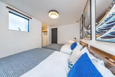 a bedroom with two beds and a window at Modern Japan \u6771\u4eac\u6d45\u8349 east in Tokyo