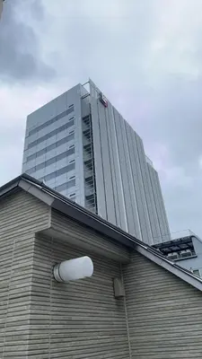 a building with a tall building in the background at Miaoyi Asakusa in Tokyo