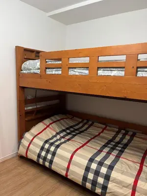 a bunk bed in a room with a wooden floor at Miaoyi Asakusa in Tokyo