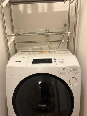 a white washing machine in a laundry room at Miaoyi Asakusa in Tokyo
