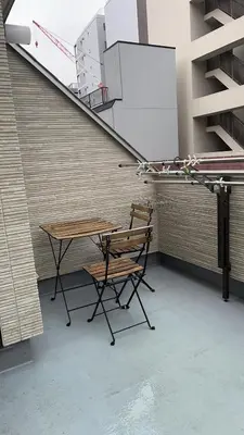 a table and a chair in front of a building at Miaoyi Asakusa in Tokyo