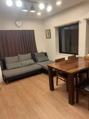 a living room with a couch and a table at Miaoyi Asakusa in Tokyo