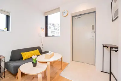 a living room with a couch and a table at New Cozy APT Located on the Japanese Local shopping street in Tokyo