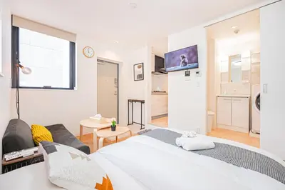 a bedroom with a bed and a living room at New Cozy APT Located on the Japanese Local shopping street in Tokyo