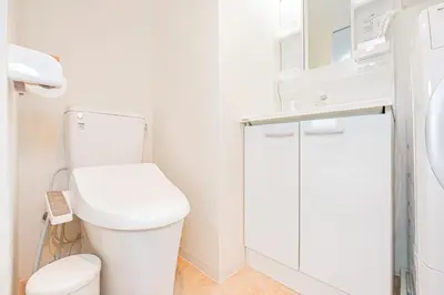 a white bathroom with a toilet and a sink at New Cozy APT Located on the Japanese Local shopping street in Tokyo