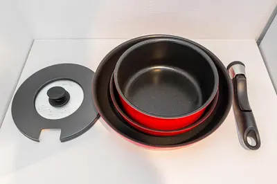 a red bowl on a plate next to a speaker at New Cozy APT Located on the Japanese Local shopping street in Tokyo