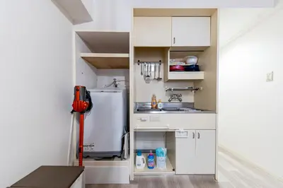 a small kitchen with a sink and a refrigerator at Shinjuku myroom in Tokyo