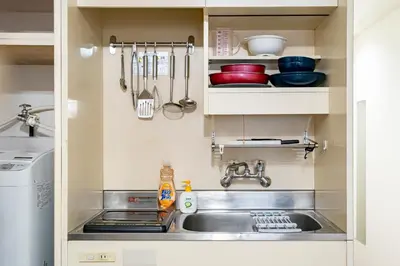 a kitchen with a sink and a dishwasher at Shinjuku myroom in Tokyo