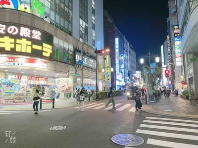 a busy city street at night with people crossing the street at ikebukuro VX hefuyan7190 in Tokyo