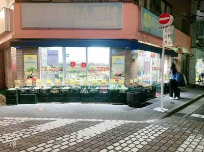 a woman standing in front of a store on a street at ikebukuro VX hefuyan7190 in Tokyo