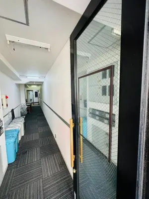 a hallway of an office with a glass door at ikebukuro VX hefuyan7190 in Tokyo