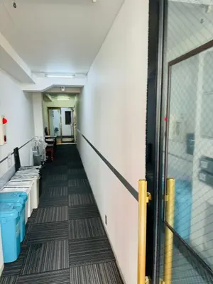 a hallway in an office building with blue trash cans at ikebukuro VX hefuyan7190 in Tokyo