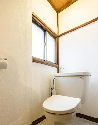 a white toilet in a bathroom with a window at HOTEL Shibuya Tomigaya in Tokyo