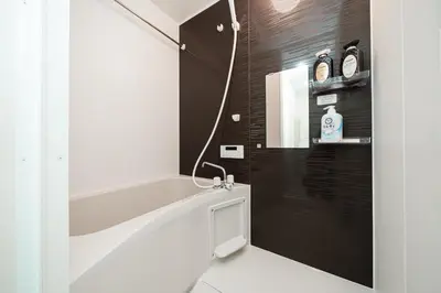 a bathroom with a white sink and a mirror at Momo-stay Ikebukuro in Tokyo