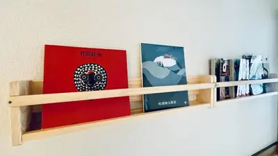 a shelf with books and books on a wall at Shinjuku spacious apartment for max 8ppl in Tokyo