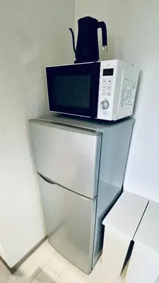 a microwave sitting on top of a refrigerator at Shinjuku spacious apartment for max 8ppl in Tokyo