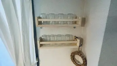 a bunch of glasses on shelves in a room at Shinjuku spacious apartment for max 8ppl in Tokyo