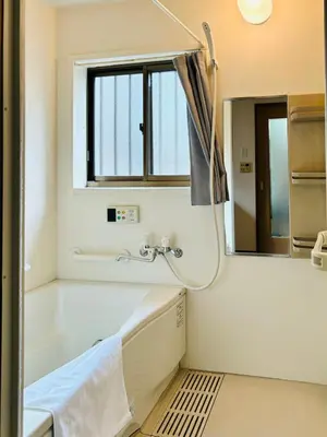 a bathroom with a tub and a sink and a mirror at Holiday Akabane House - A Traditional Japanese House in Tokyo, with Direct Access to Shinjuku & Shibuya in Tokyo