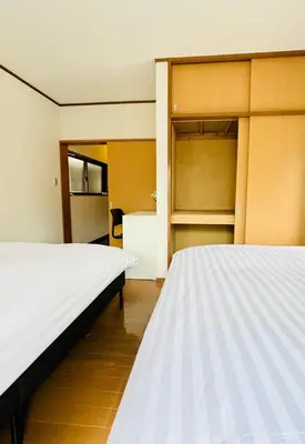 two beds in a room with two closets at Holiday Akabane House - A Traditional Japanese House in Tokyo, with Direct Access to Shinjuku & Shibuya in Tokyo