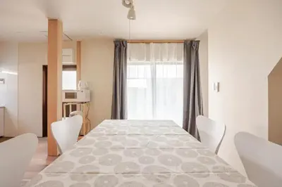 a dining room with a large table and chairs at \u6771\u6d45\u83492\u4e01\u76eeb101 in Tokyo