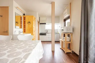 a small room with a bed and a kitchen at \u6771\u6d45\u83492\u4e01\u76eeb101 in Tokyo