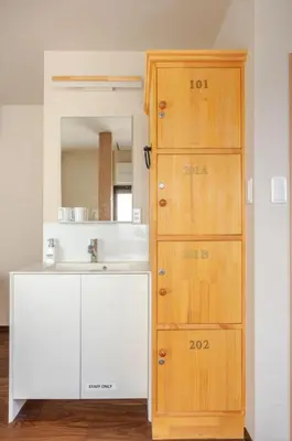 a bathroom with a sink and a wooden cabinet at \u6771\u6d45\u83492\u4e01\u76eeb101 in Tokyo