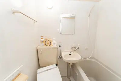 a bathroom with a sink and a toilet and a shower at E JOY INN-Higashi Nipoori in Tokyo