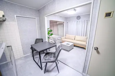 a small living room with a table and a couch at 1 line to Asakusa! Projector, 5 mins walk from Togoshi-ginza Sta in Tokyo