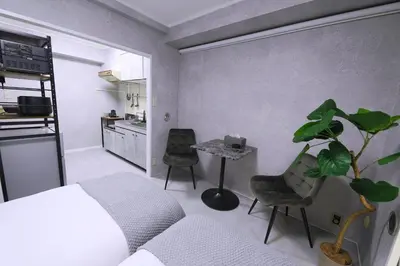 a living room with a couch and a table with a plant at 1 line to Asakusa! Projector, 5 mins walk from Togoshi-ginza Sta in Tokyo