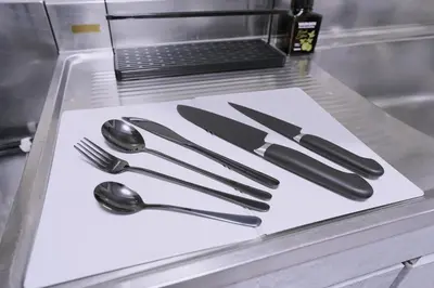 a table with utensils on a counter with a laptop at 1 line to Asakusa! Projector, 5 mins walk from Togoshi-ginza Sta in Tokyo