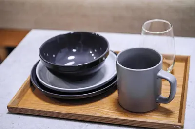 a black cup and plates and a glass on a wooden tray at 1 line to Asakusa! Projector, 5 mins walk from Togoshi-ginza Sta in Tokyo