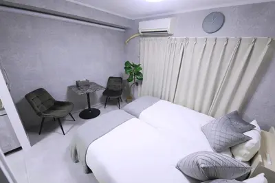 a bedroom with a white bed and a table and chair at 1 line to Asakusa! Projector, 5 mins walk from Togoshi-ginza Sta in Tokyo
