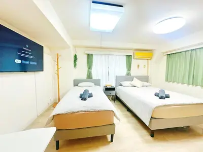 a hospital room with two beds and a tv at \u65b0\u5bbf\u5e02\u4e2d\u5fc3\u6b4c\u821e\u4f0e\u753a\u6771\u65b0\u5bbf\u99c5\u5f92\u6b653\u5206\u9418\u514d\u8cbbWi-Fi in Tokyo