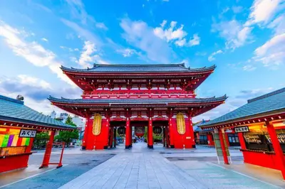 a large building with red columns and a sky at The Geminis Ikebukuro301 in Tokyo