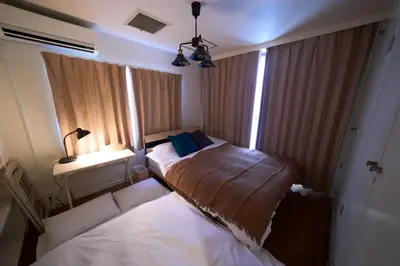 a small bedroom with two beds and a window at Nakagawa Building - Vacation STAY 17546 in Tokyo
