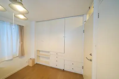 a bedroom with a large white cabinet in a room at Nakagawa Building - Vacation STAY 17546 in Tokyo