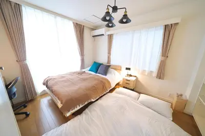 a bedroom with two beds and a window at Nakagawa Building - Vacation STAY 17546 in Tokyo