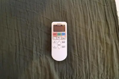 a remote control sitting on top of a table at Nakagawa Building - Vacation STAY 17546 in Tokyo