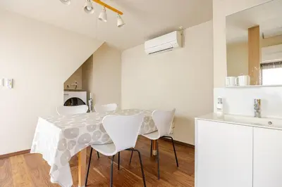 a kitchen with a table and chairs in a room at \u6771\u6d45\u83492\u4e01\u76eeb201 in Tokyo