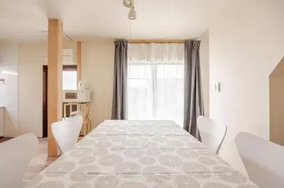 a dining room with a table and chairs and a window at \u6771\u6d45\u83492\u4e01\u76eeb201 in Tokyo